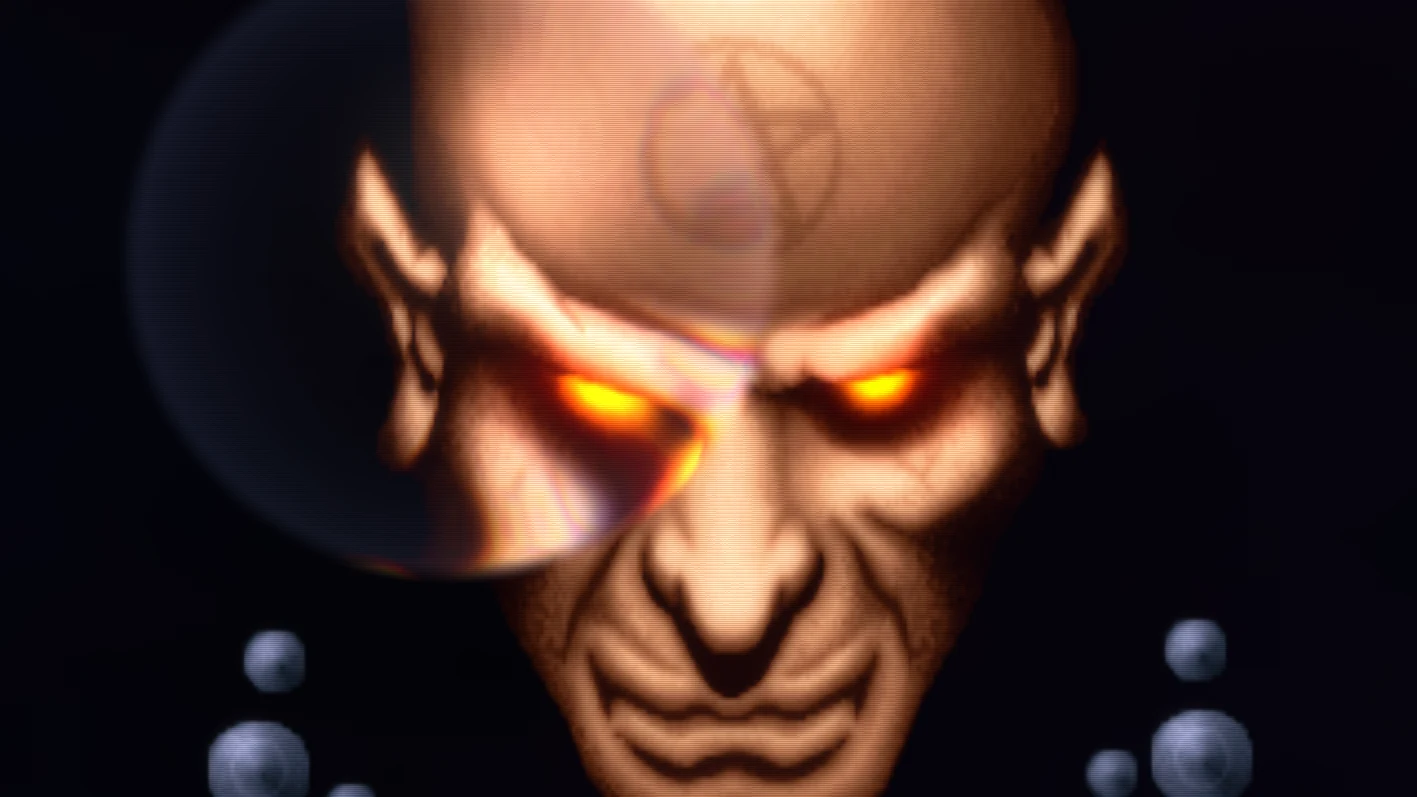 The remastered crystal ball effect: a bald demon's face with glowing orange eyes, seen through a glass sphere, with small metal balls at the sides